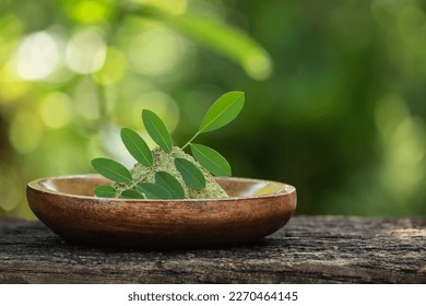 Indigo green leaves and powder on nature background. - Shutterstock ID 2270464145