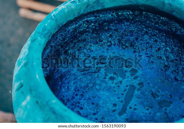 Indigo\
water, Indigo plant fermentation in clay\
pot