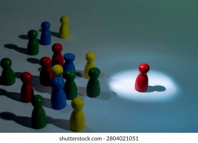 Individual isolated under spotlight while crowd remains in darkness