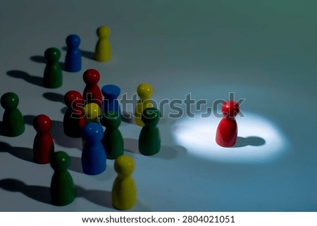 Individual isolated under spotlight while crowd remains in darkness