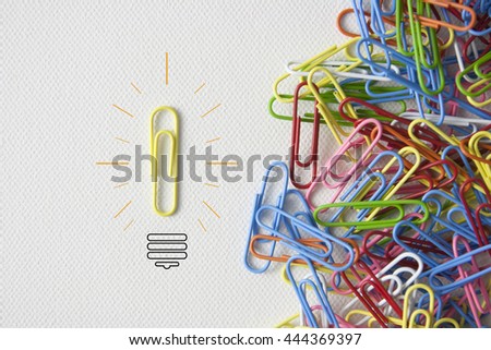  Individual paperclip  going in the opposite direction as a business icon for innovative thinking.