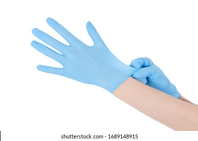 Individual protection products vinyl disposable gloves in the spread of virus and protection against infections. Women is dressing her hands in gloves. The coronavirus protection trend is COVID-19.