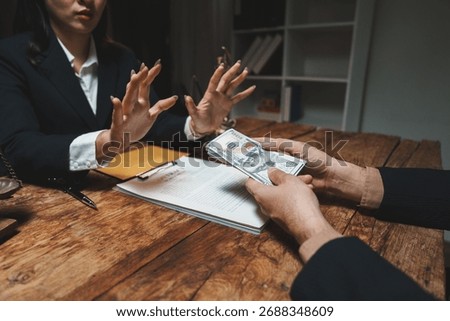 Individual in a suit refusing a stack of cash, indicating a strong stance against bribery and unethical practices