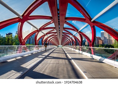 An individual walks across the Peace Bridge near downtown Calgary, Alberta, Canada.