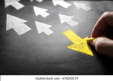Individuality chalk arrow going a different direction on blackboard - Shutterstock ID 670243174