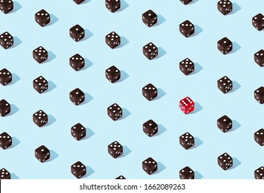 Individuality concept. Red dice standing behind the crowd of plenty identical black ones. Leadership, uniqueness, independence, initiative, strategy, , think different, business success concept