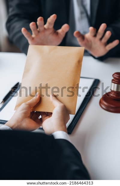 Individuals are giving bribes to officials in\
order to commit corruption in lawsuits, illegal actions by law\
enforcement by paying bribes to officials are illegal and unlawful.\
Fraud concept.