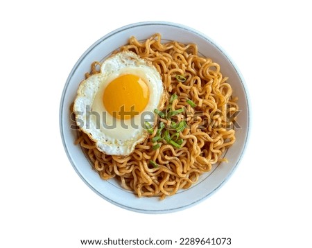 Indomie fried noodles. Indomie stir fry noodles on white background isolated. A bowl of instant noodles with sunny side up egg. Indonesian instant noodles cooked  