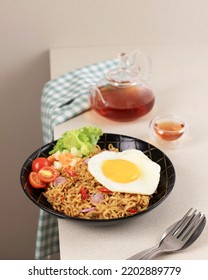 Indomie Goreng, Favorite Most Popular Instant Noodle Brand From Indonesia. Served With Vegetable And Sunny Side Egg