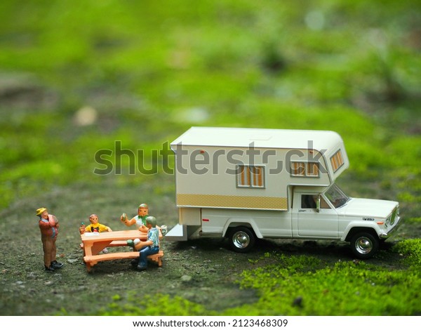 Indonesia - February 8, 2022 : Adventure,
holiday and staycation conceptual design with mini toy. Blurred
green land view, there is unfocus mini
toys.