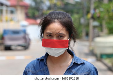 Indonesia flag on hygienic mask. Masked Asian woman prevent germs and wear denim skirt dress. concept of Tiny Particle protection or virus corona or Covid 19. - Shutterstock ID 1685191618