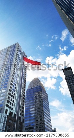indonesia flag at sudirman city, blue sky and beautiful  buldings with indonesian flag, hut RI 
bendera indonesia scbd hut ri 77 tahun