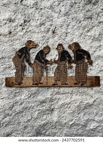 Indonesia, June 21, 2021 : An ornament of four-wayang characters on a stone wall. These figures, known as 