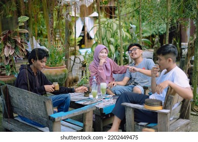 Indonesia, Makassar - September 13, 2022 : A Group Of Teenagers Hanging Out At A Cafe