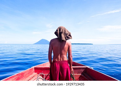 INDONESIA, MANADO - JUNE 10, 2018: A Local Navigator Guided The Ship's Direction. Without Sophisticated Equipment, Experience And Focus Are Crucial. Selective Focus And Shallow Depth Of Field.