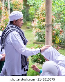 
Indonesia, March 03, 2022, A Religious Leader Praying For His Students