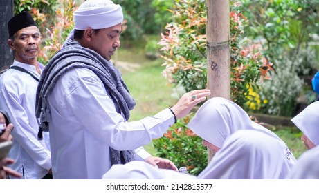 
Indonesia, March 03, 2022, A Religious Leader Praying For His Students