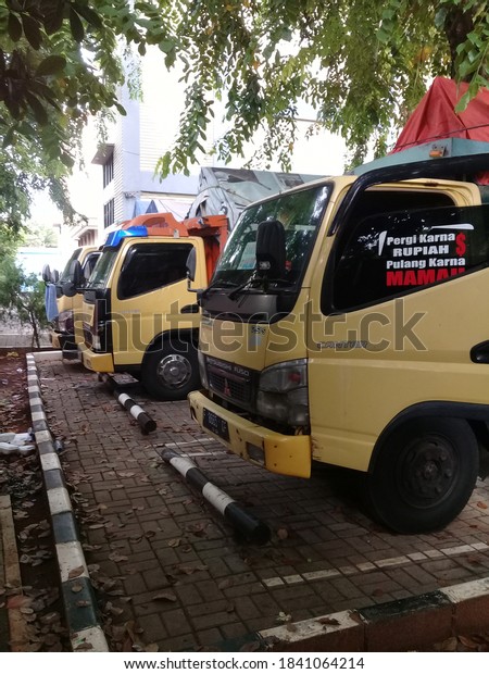 Indonesia, October 25,2020, colt diesel truck drivers\
and cars in the parking\
lot