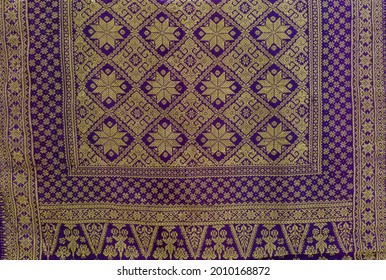 Indonesia traditional fabric from Palembang (songket), purple and gold color in Lepus motive. 