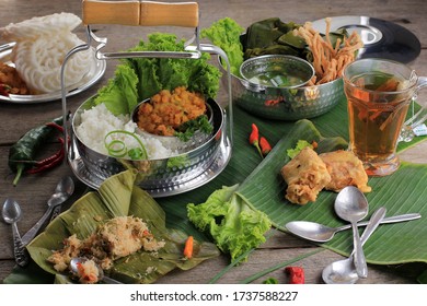 Indonesian Comfort Food Family Menu: Rice With Sayur Bayam, Tea, Steam Bothok, And Corn Fritter. Accompanied With Chilli Paste (Sambal), Kerupuk, And Vegetable Fritter. Popular Daily Cooking 