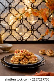 Indonesian Cookies (Fruit Pie), Popular Cookies During Hari Raya Idul Fitri And Christmas Served On Brown Plate, Golden Table And Background. 