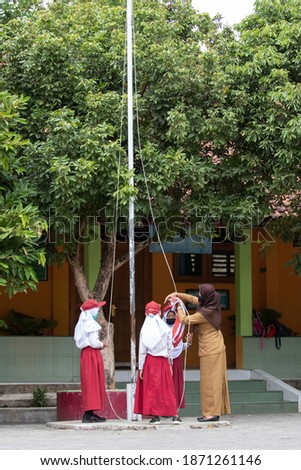 Indonesian elementary student do flag raising preparation in school