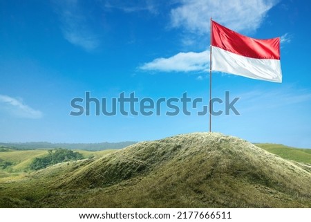 Indonesian flag on the pole waving with blue sky background