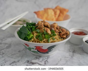 Indonesian food, Mie Ayam or Bami ayam, noodles with chicken and served with meatballs and deep-fried wonton pangsit