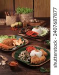 indonesian food on table. Assorted indonesian food set. nasi ayam penyet, nasi goreng sambal geprek, nasi ayam bakar, Famous indonesian cuisine dishes on table, with traditional concept
