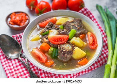 Indonesian Food Sop Buntut  Oxtail Clear Soup With Vegetables And Served With Chili Sauce Sambal 