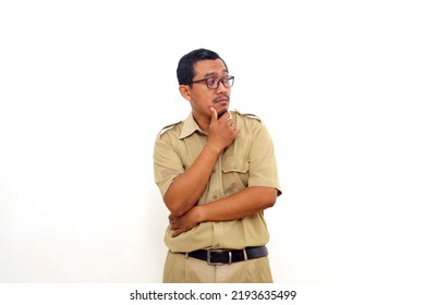 Indonesian government employees standing while glancing sideways. Isolated on white background