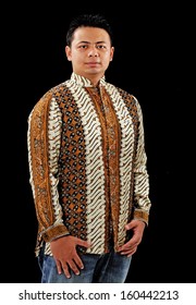 Indonesian man on batik, isolated on black