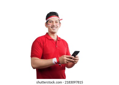 Indonesian men celebrate Indonesian independence day on 17 August while holding mobile phones isolated over white background - Shutterstock ID 2183097815