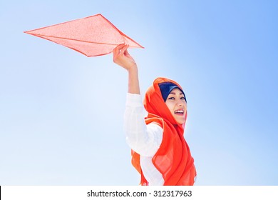 Indonesian Muslim Woman Playing With A Kite On Independence Day