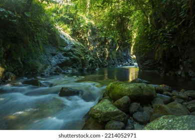 Indonesian natural scenery with a beautiful waterfall in the middle of a tropical forest