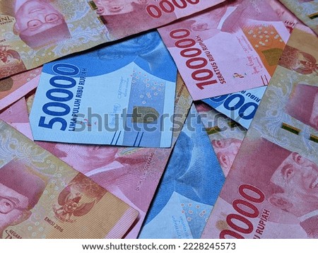 Indonesian rupiah currency notes in one hundred thousand and five thosand  isolated against white background