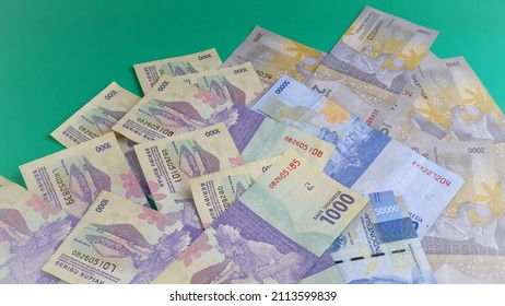 Indonesian Rupiah the official currency of Indonesia. Business finance investment saving and success concept. Uang 1000 Rupiah. Bank Indonesia. Green Background. - Shutterstock ID 2113599839