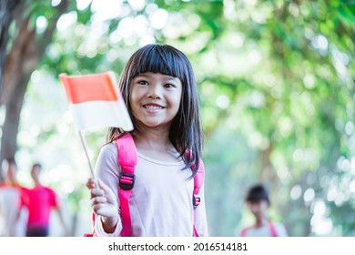 Indonesian School Student Holding Flag During Independence Day.