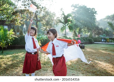 Indonesian School Student Holding Flag During Independence Day.