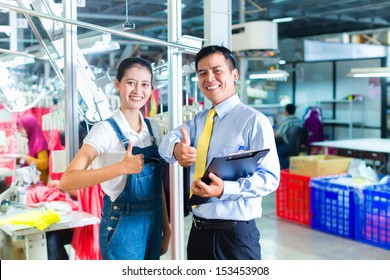 Indonesian Seamstress is new assigned in a textile factory, the foreman gives her training for the new job - Powered by Shutterstock