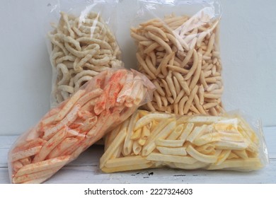 Indonesian snack called potato, spicy potato, cork egg, and alen-alen in plastic on the table - Shutterstock ID 2227324603