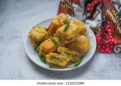 Indonesian street food, Fried Tofu Filled With Vegetables(Tahu Isi) served with fresh green chili