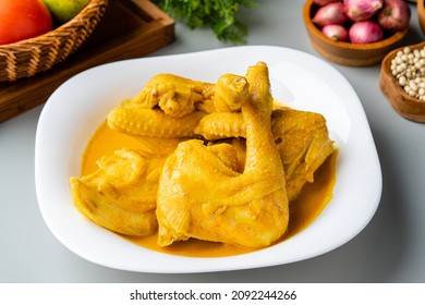 Indonesian Traditional cuisine : Ayam Gulai Padang. Ayam Gulai is a popular dish of chicken curry from Padang, West Sumatra. served on plate and isolated on gray background.
