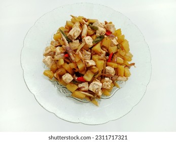 Indonesian traditional dish named "tumis tahu kentang teri cabe hijau" that is stir-fried tofu, potatoes and green chili anchovies served on a plate, isolated on a white background - Shutterstock ID 2311717321