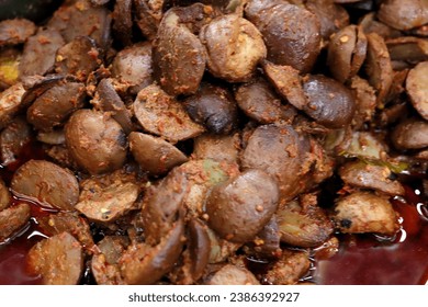 Indonesian traditional food named "semur jengkol" i.e. jering cooked with spices and soysauce, close up view