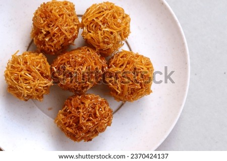 Indonesian traditional snack named 'grubi' i.e. grubi made from thin slices cassava cooked with palm sugar and rounded shaped, served on plate isolated on white background, top view Zdjęcia stock © 