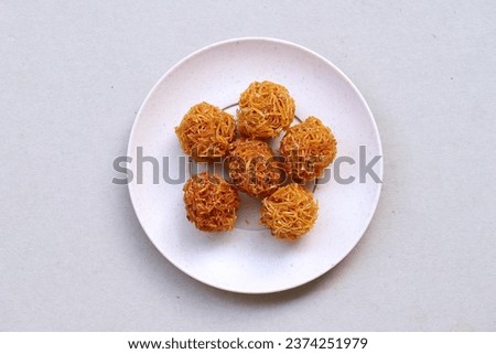 Indonesian traditional snack named 'grubi' i.e. grubi made from thin slices cassava rounded shaped cooked with palm sugar, served on plate isolated on white background, top view Zdjęcia stock © 