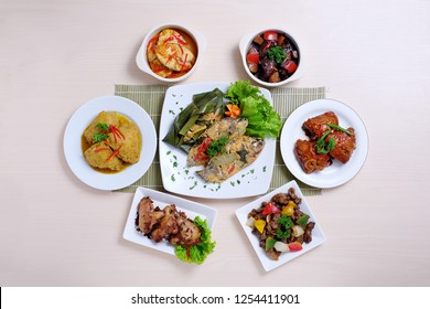 Indonesian Variety Food Flat Lay With Different Delicious Asian Malay Dishes. Top View Of Plates With Different Menu On Table. 