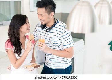 Indonesian Woman And Man In Their Kitchen, They Are A Couple