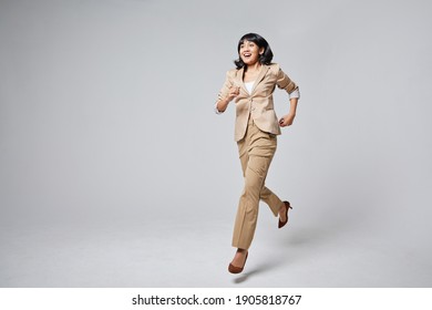 A Indonesian Woman Running In A Suit